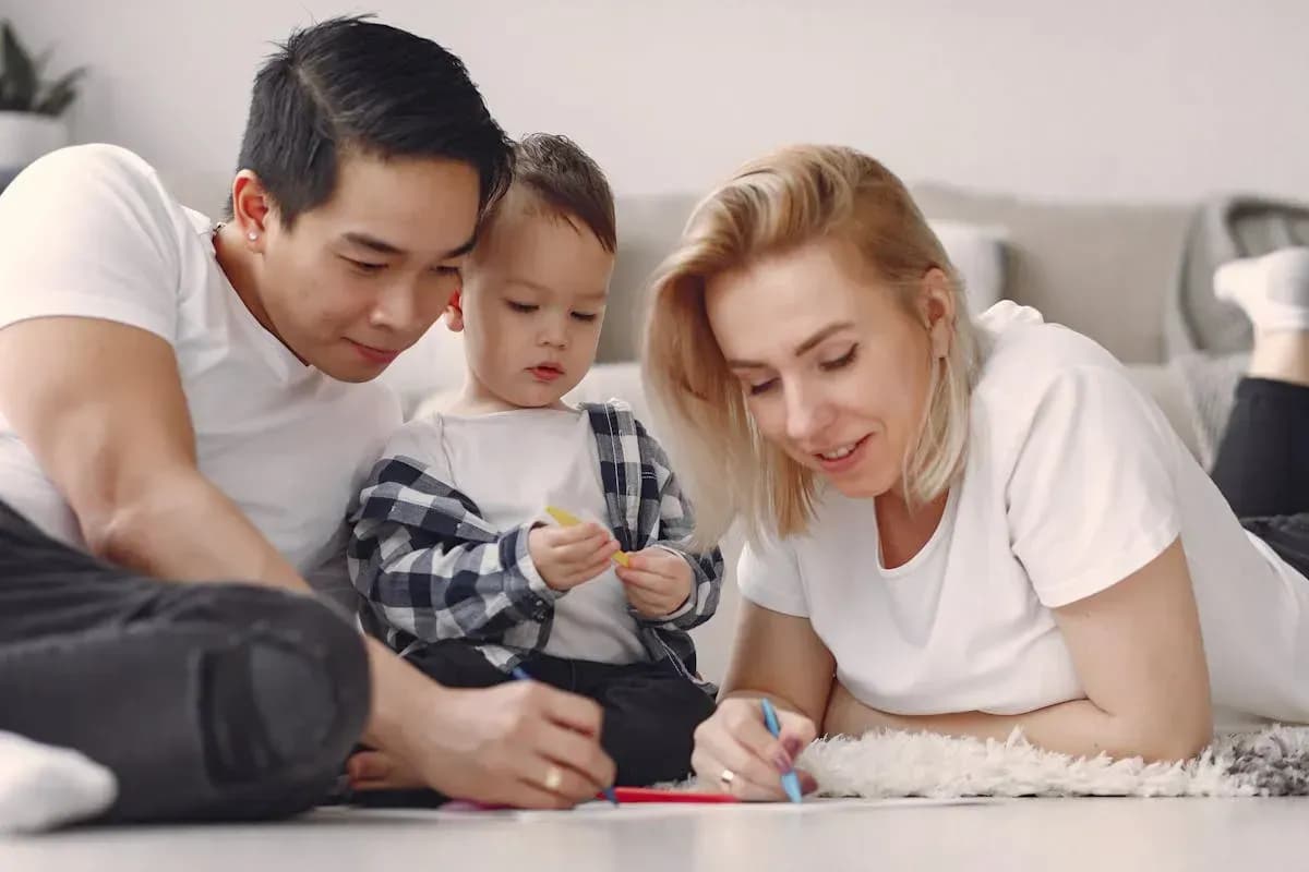 Parent and child creating colourful art together at a table