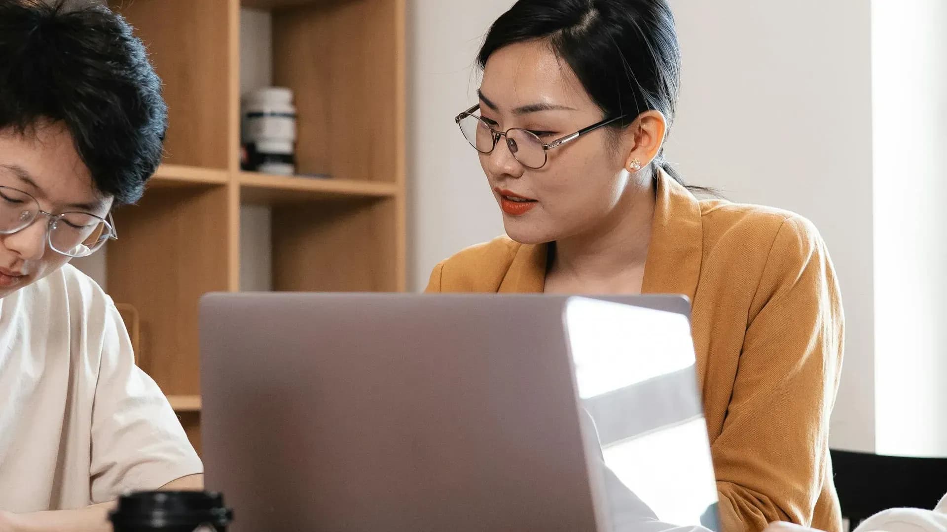 Two professionals working confidently with AI, looking forward