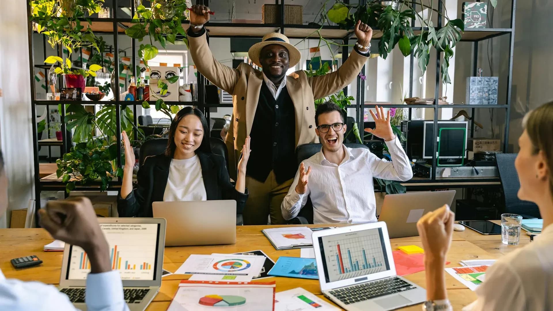 Team celebrating productivity wins together at their desks