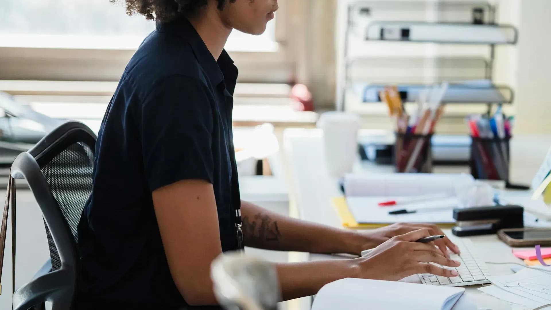 Focused professional crafting advanced prompts at her computer