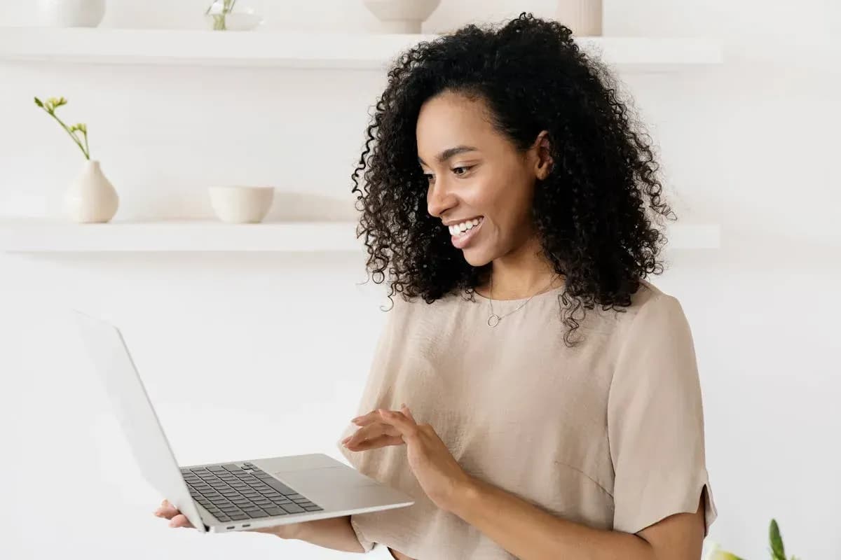 Woman working on laptop with notebook planning a side project