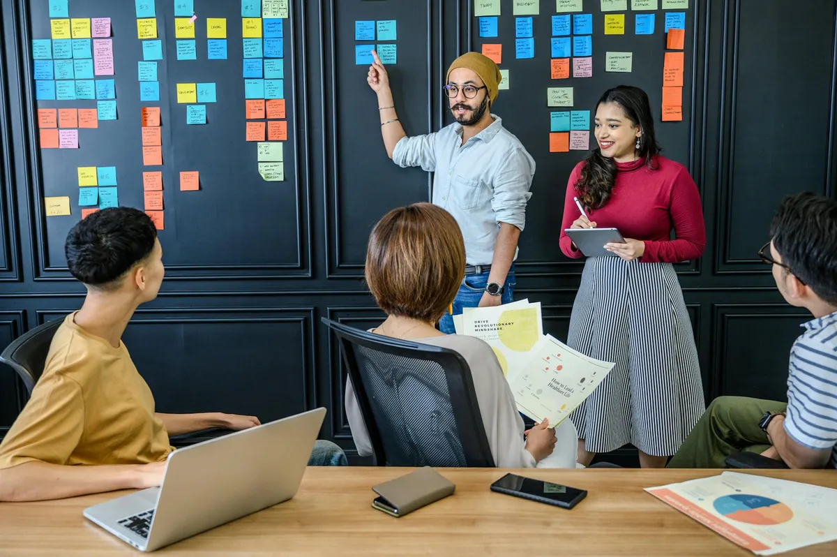 Professional team working through a complex problem using visual mapping and AI-assisted analysis on a digital whiteboard